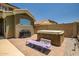 Private backyard with a hot tub, grill, and outdoor seating area on a brick patio at 17493 W Arroyo Way, Goodyear, AZ 85338