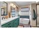Bathroom featuring double sinks, a soaking tub, modern fixtures, and neutral colors at 17493 W Arroyo Way, Goodyear, AZ 85338