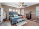 Comfortable bedroom featuring a blue bed frame, matching bench, and plush carpet at 17493 W Arroyo Way, Goodyear, AZ 85338