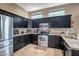 Modern kitchen features granite countertops, stainless steel appliances, and ample cabinet space at 17493 W Arroyo Way, Goodyear, AZ 85338