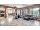 Spacious living room with tile flooring, comfortable seating, and seamless flow into the dining area at 17493 W Arroyo Way, Goodyear, AZ 85338