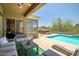Outdoor space boasts a covered patio, comfortable seating, and a pool with a spa at 17493 W Arroyo Way, Goodyear, AZ 85338