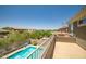 Resort-style swimming pool with a waterfall feature and lush landscaping at 17493 W Arroyo Way, Goodyear, AZ 85338