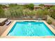 Private backyard pool with a waterfall feature and mature landscaping at 17493 W Arroyo Way, Goodyear, AZ 85338