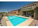 Backyard features a sparkling pool, covered patio, and ample space for entertaining at 17493 W Arroyo Way, Goodyear, AZ 85338
