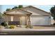 Charming single-story home with a well-manicured lawn and a two-car garage at 17524 W Woodlands Ave, Goodyear, AZ 85338
