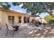 Inviting backyard patio with shade umbrella, outdoor seating, and beautiful desert landscaping at 19403 E Apricot Ln, Queen Creek, AZ 85142