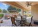 Relaxing covered patio with ceiling fan, seating area, and a view of the backyard at 19403 E Apricot Ln, Queen Creek, AZ 85142