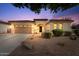 Charming single-story home boasts a well-manicured landscape, a two-car garage, and inviting curb appeal at 19403 E Apricot Ln, Queen Creek, AZ 85142