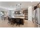 Modern kitchen features a large island, stainless steel appliances, and a breakfast bar with seating at 19403 E Apricot Ln, Queen Creek, AZ 85142