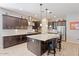 Stylish kitchen with granite countertops, a center island with seating, stainless steel appliances, and modern lighting at 19403 E Apricot Ln, Queen Creek, AZ 85142