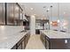 Spacious kitchen boasts an expansive island, granite countertops, stainless steel appliances, and ample cabinet space at 19403 E Apricot Ln, Queen Creek, AZ 85142