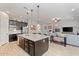 Open concept kitchen with granite countertops, stainless steel appliances, and large island with dark wood cabinets at 19403 E Apricot Ln, Queen Creek, AZ 85142