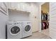Bright laundry room features modern appliances and direct access to a walk-in closet at 19403 E Apricot Ln, Queen Creek, AZ 85142