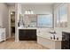 Well-lit main bathroom features a soaking tub, a walk-in shower, and a large mirror over a dark vanity at 19403 E Apricot Ln, Queen Creek, AZ 85142
