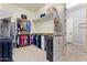 Organized walk-in closet with hanging racks and shelves for ample storage at 19403 E Apricot Ln, Queen Creek, AZ 85142