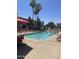 Community swimming pool with lounge chairs, umbrellas, and well-kept patio area at 1941 S Pierpont Dr # 2062, Mesa, AZ 85206