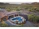 Aerial view of a desert home with a tiled roof, pool, patio, and desert landscape at 1943 E Paso Nuevo Dr, Phoenix, AZ 85086