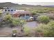 Expansive aerial view showcasing a desert home with a pool, fire pit, and mountain views at 1943 E Paso Nuevo Dr, Phoenix, AZ 85086