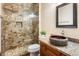 Contemporary bathroom with a stone shower, vanity, and granite countertop at 1943 E Paso Nuevo Dr, Phoenix, AZ 85086