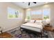 This comfortable bedroom has neutral walls, a modern ceiling fan, and bright, shuttered windows at 1943 E Paso Nuevo Dr, Phoenix, AZ 85086