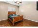 Cozy bedroom features a wood-frame bed, rustic decor and ample natural light at 1943 E Paso Nuevo Dr, Phoenix, AZ 85086