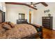 Warm bedroom with wood-beamed ceilings, a large dresser, and rustic decor at 1943 E Paso Nuevo Dr, Phoenix, AZ 85086