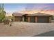 Charming single-story home with a tile roof and two-car garage against a desert sunset at 1943 E Paso Nuevo Dr, Phoenix, AZ 85086