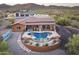 Exterior shot highlighting a desert home with a pool, covered patio, and lush desert landscape at 1943 E Paso Nuevo Dr, Phoenix, AZ 85086