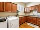 This spacious laundry room features granite countertops, ample cabinets, and a laundry sink at 1943 E Paso Nuevo Dr, Phoenix, AZ 85086