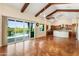 Bright living room with patio access, beamed ceilings, and an open layout at 1943 E Paso Nuevo Dr, Phoenix, AZ 85086