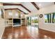 Bright living room with beamed ceilings, fireplace, built-in shelving, and ample natural light at 1943 E Paso Nuevo Dr, Phoenix, AZ 85086