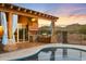 Covered patio with an outdoor kitchen, ceiling fan, and a view of the pool at 1943 E Paso Nuevo Dr, Phoenix, AZ 85086