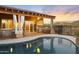 Stunning backyard featuring a pristine pool, covered patio with an outdoor kitchen, and views of a mountain backdrop at 1943 E Paso Nuevo Dr, Phoenix, AZ 85086