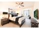 Modern bedroom featuring a king bed, ceiling fan, and dark wood accents at 2511 W Queen Creek Rd # 325, Chandler, AZ 85248