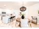 Bright dining area featuring a round table, stylish chairs, and an open view to the modern kitchen at 2511 W Queen Creek Rd # 325, Chandler, AZ 85248