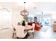 Open-concept dining area flows into a living space with a cozy couch and access to an outdoor patio at 2511 W Queen Creek Rd # 325, Chandler, AZ 85248