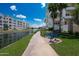 Scenic lakeside condos featuring lush landscaping, walking paths, and charming blue park benches at 2511 W Queen Creek Rd # 325, Chandler, AZ 85248