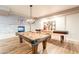 Community game room with billiards, shuffleboard, fireplace and comfortable furniture at 2511 W Queen Creek Rd # 325, Chandler, AZ 85248