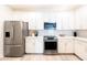 Well-equipped kitchen featuring stainless steel appliances, white cabinets, and subway tile backsplash at 2511 W Queen Creek Rd # 325, Chandler, AZ 85248