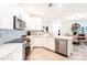 Modern kitchen with stainless steel appliances, quartz countertops and a view of the open-concept living space at 2511 W Queen Creek Rd # 325, Chandler, AZ 85248