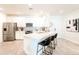 Bright kitchen featuring white cabinetry, stainless steel appliances, and a large center island with seating at 2511 W Queen Creek Rd # 325, Chandler, AZ 85248