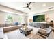 Bright living room featuring a ceiling fan, large windows, and modern furniture with a decorative area rug at 2511 W Queen Creek Rd # 325, Chandler, AZ 85248