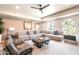 Bright living room featuring a sectional sofa, decorative pillows, area rug, and large windows at 2511 W Queen Creek Rd # 325, Chandler, AZ 85248