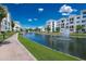 Scenic view of a pond with fountains, lush landscaping, and modern apartments in a well-maintained community at 2511 W Queen Creek Rd # 325, Chandler, AZ 85248