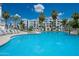 Beautiful pool with luxurious lounge chairs and tables with a view of the elegant building at 2511 W Queen Creek Rd # 325, Chandler, AZ 85248