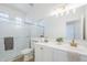 Bright bathroom featuring a walk-in shower, vanity with sink, and large mirror at 2755 N 103Rd Ave, Avondale, AZ 85392