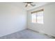 Neutral bedroom with a ceiling fan, a window with blinds, and plush carpeting at 2755 N 103Rd Ave, Avondale, AZ 85392