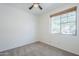 Bedroom with a ceiling fan, a window with blinds, and neutral carpeting at 2755 N 103Rd Ave, Avondale, AZ 85392