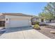Charming home exterior featuring a well-maintained lawn, desert landscaping, and two-car garage at 2755 N 103Rd Ave, Avondale, AZ 85392
